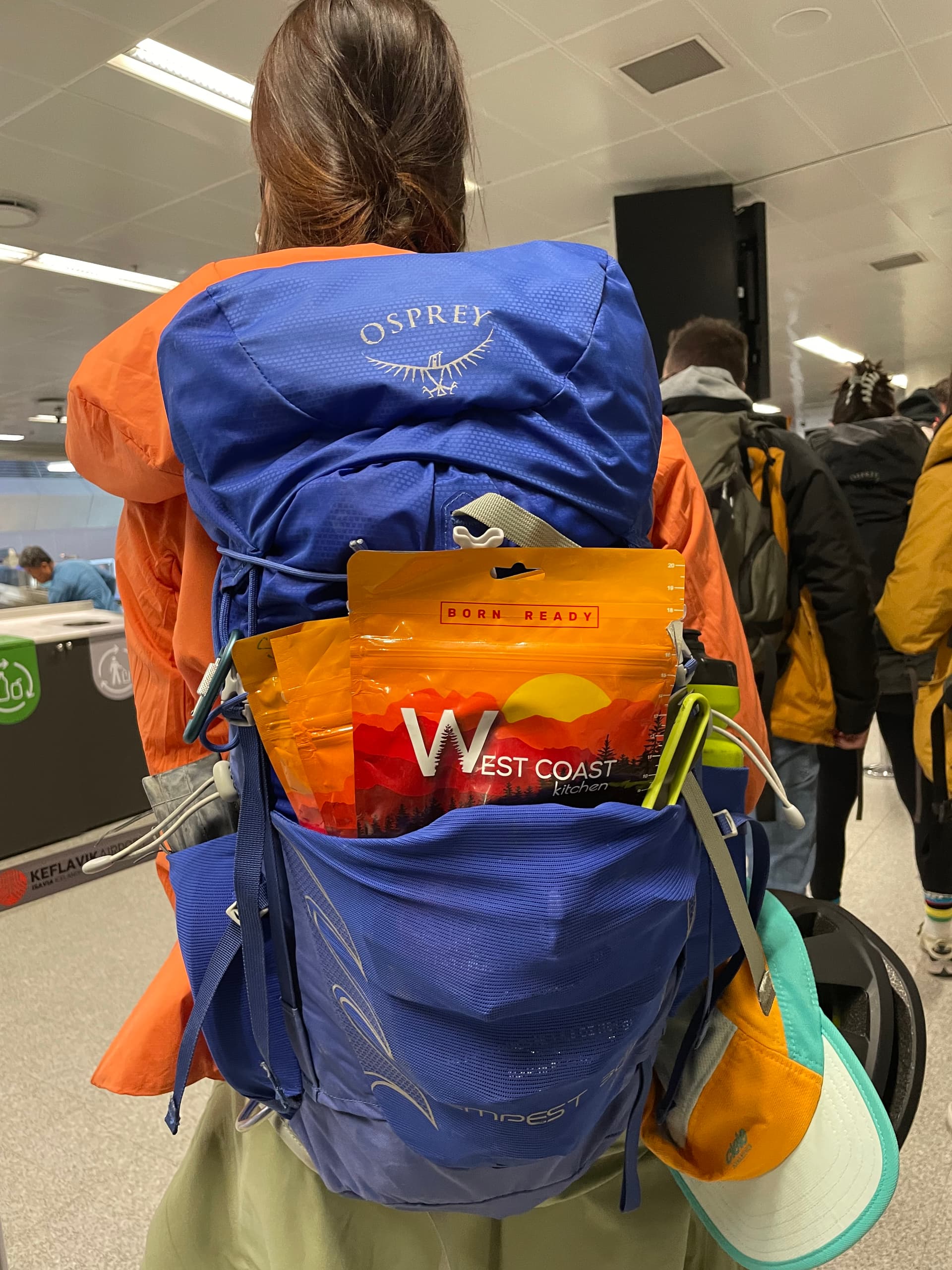 WCK pouch clipped to Osprey backpack at the airport