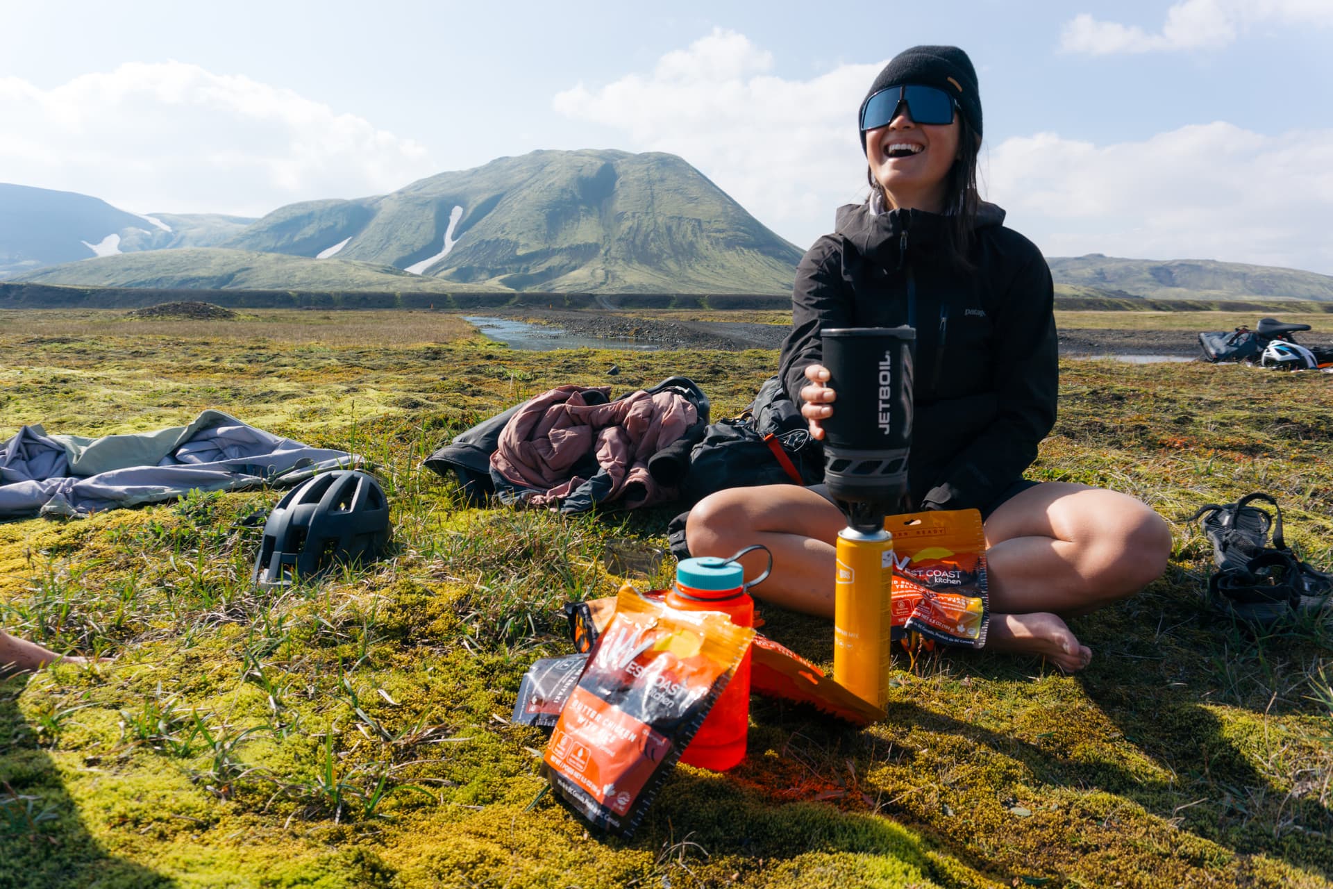 Woman laughing while cooking WCK meal with Jetboil on Icelandic highland
